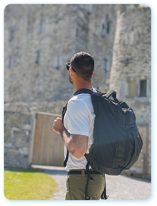 William de mochila nas costas em frente a um castelo, na Irlanda
